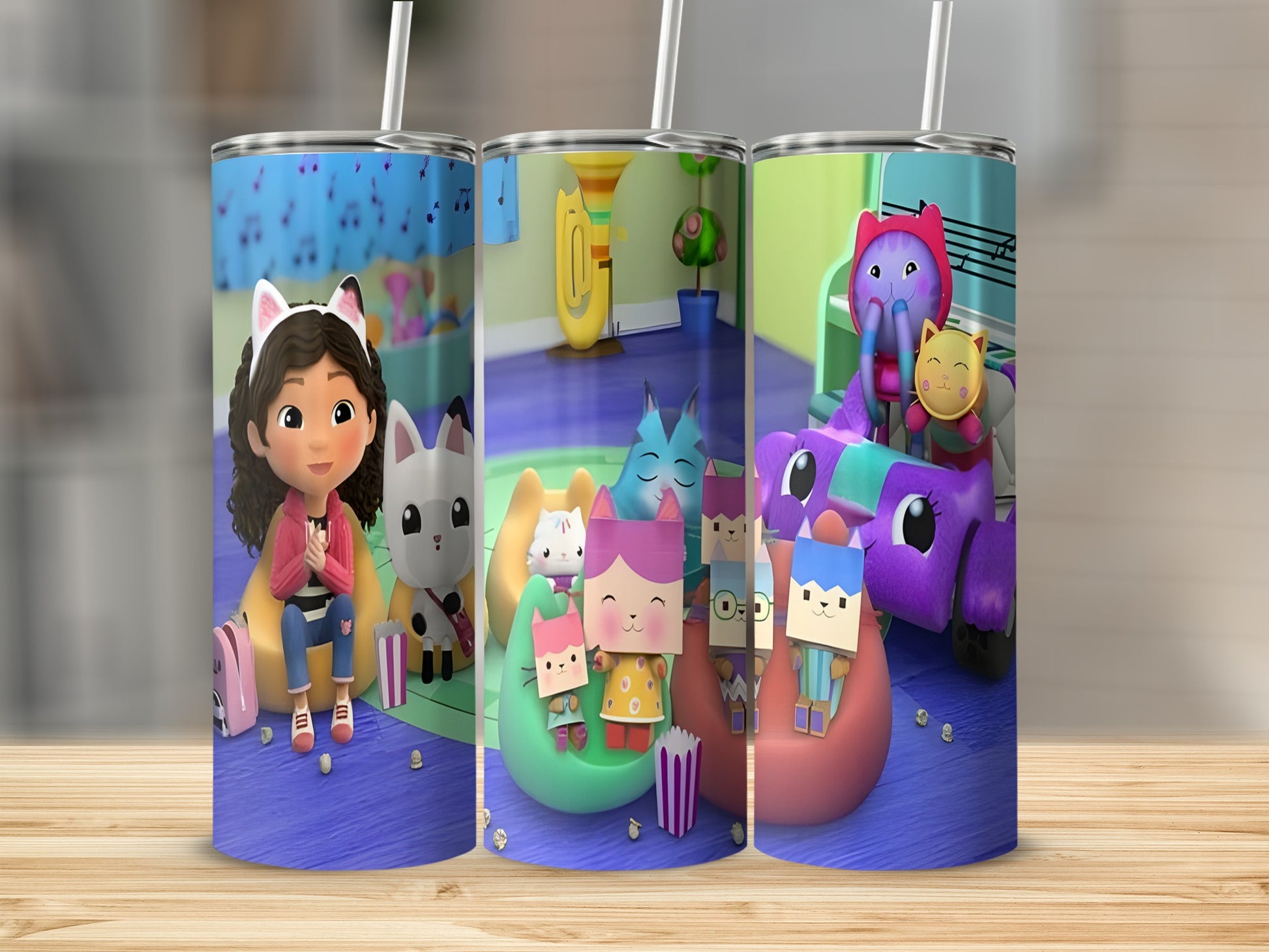 Three character cups with cartoon cats and a girl holding popcorn.