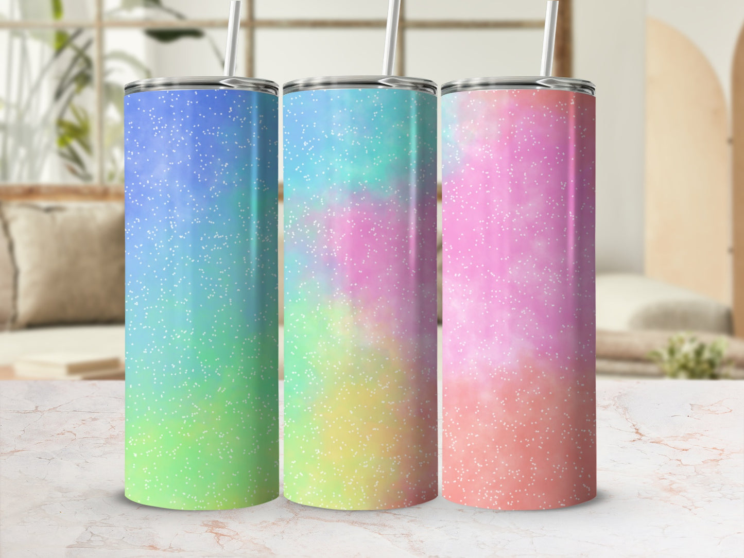 Three tall tumblers with pastel watercolor and white speckle designs.