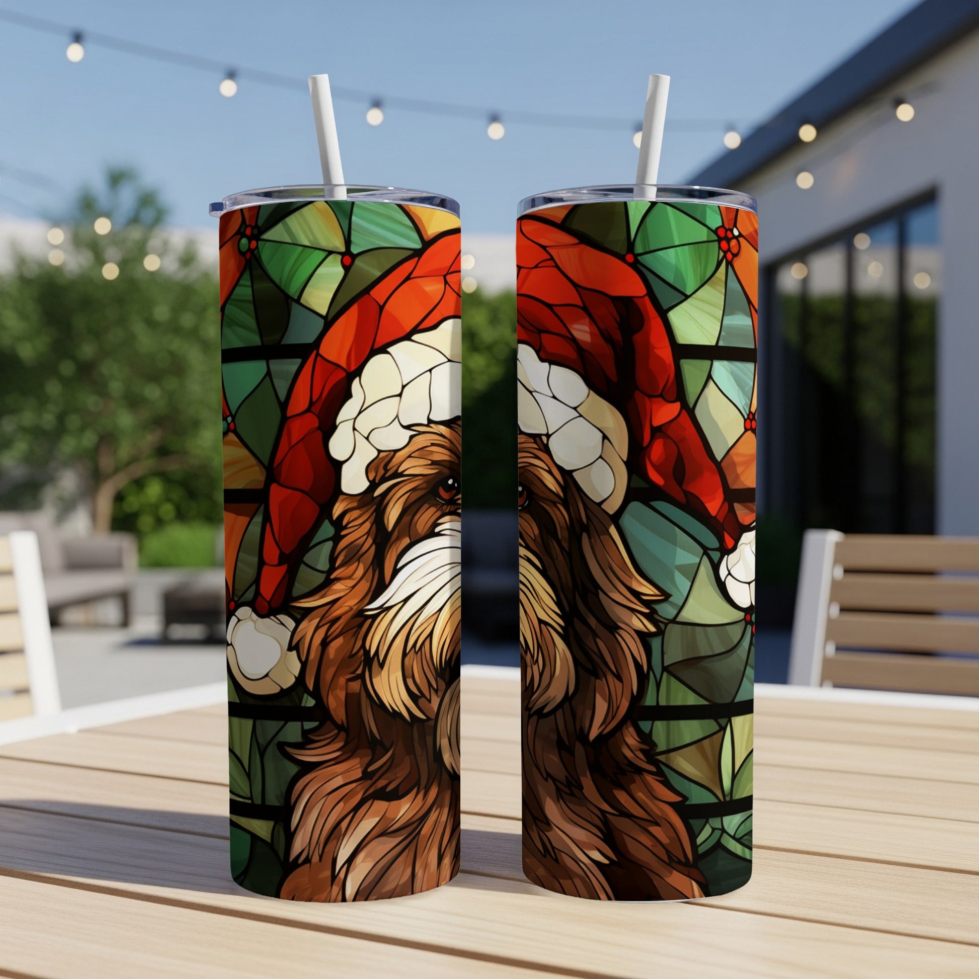Two Santa hat-wearing dogs in stained glass pattern on tumblers outdoors.