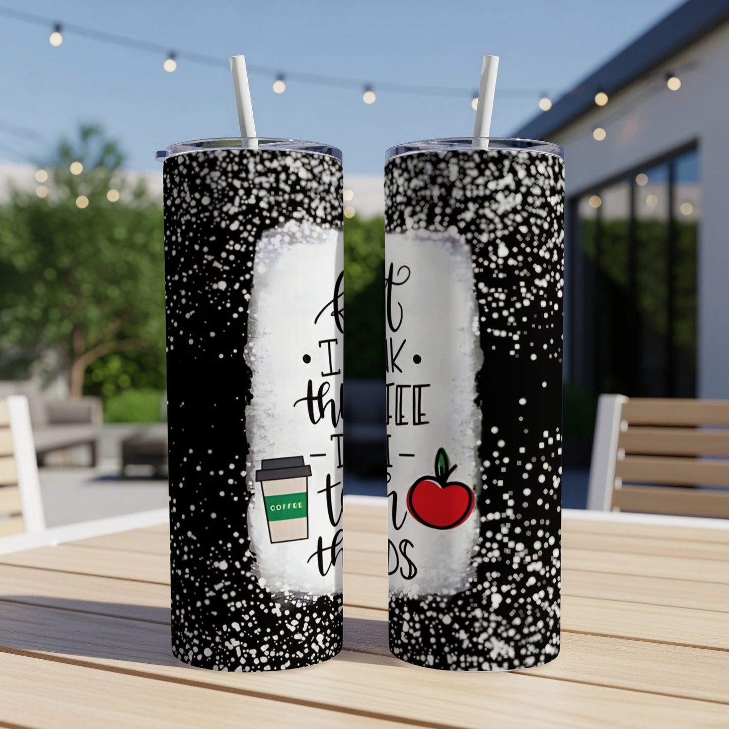 Black tumbler with white speckles, featuring text and an apple.