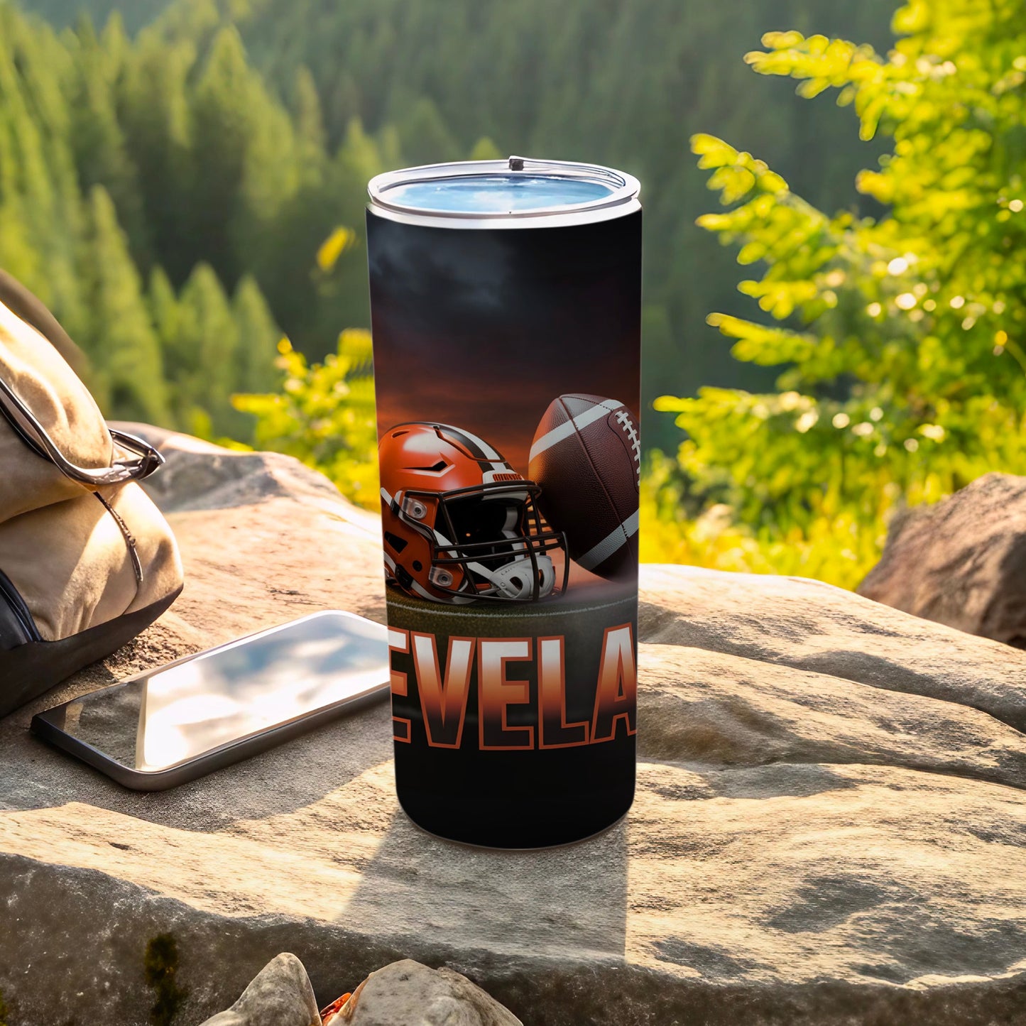 Cleveland football helmet and ball on a tumbler, outdoors.