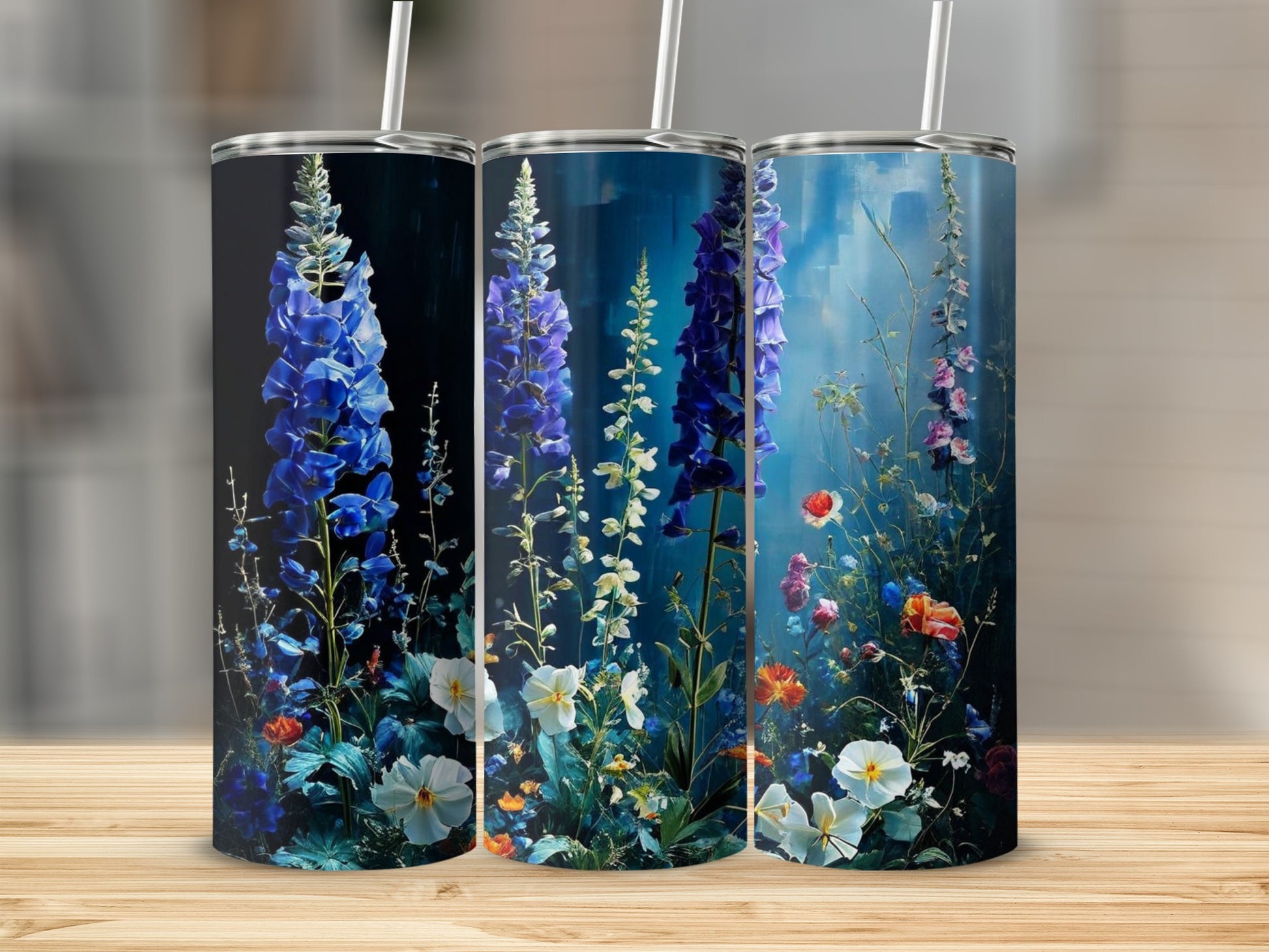 Three tumblers featuring a painterly floral design of blue delphiniums and wildflowers.