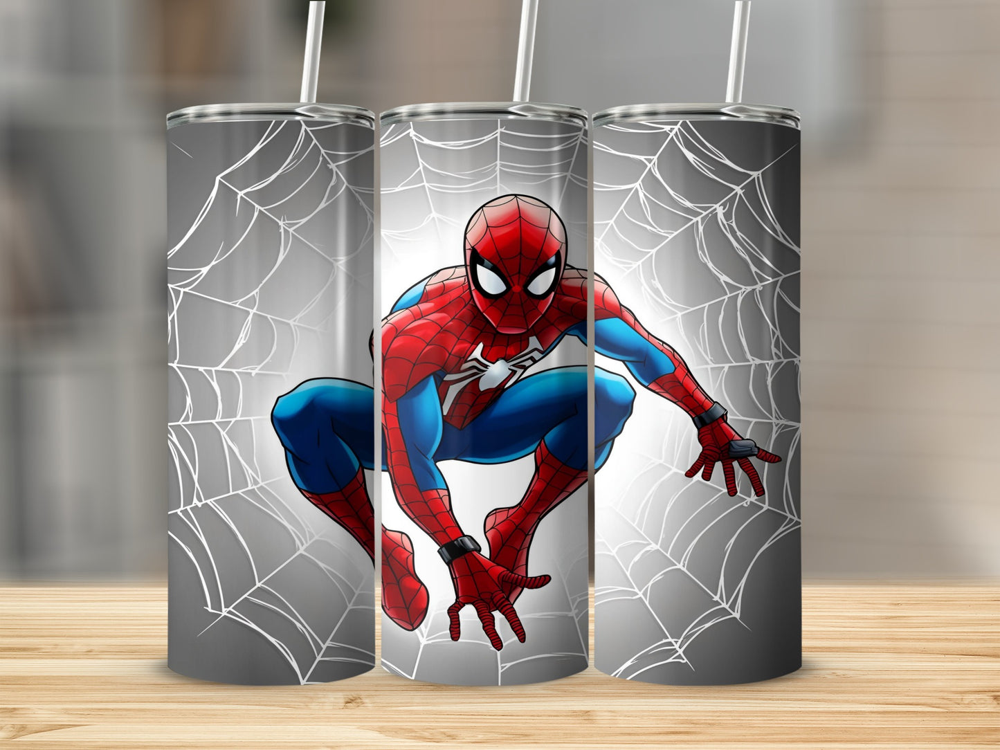Spiderman crawling on a web, shown on three tumblers.