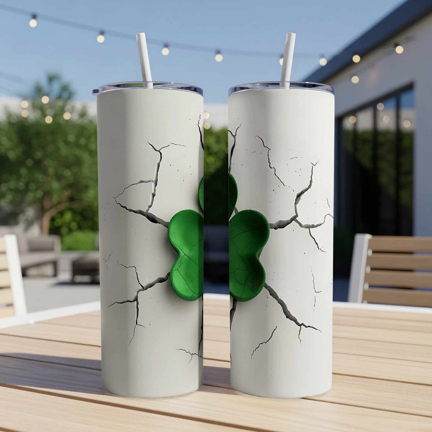 Two white tumblers with a green shamrock design breaking through cracked surfaces.