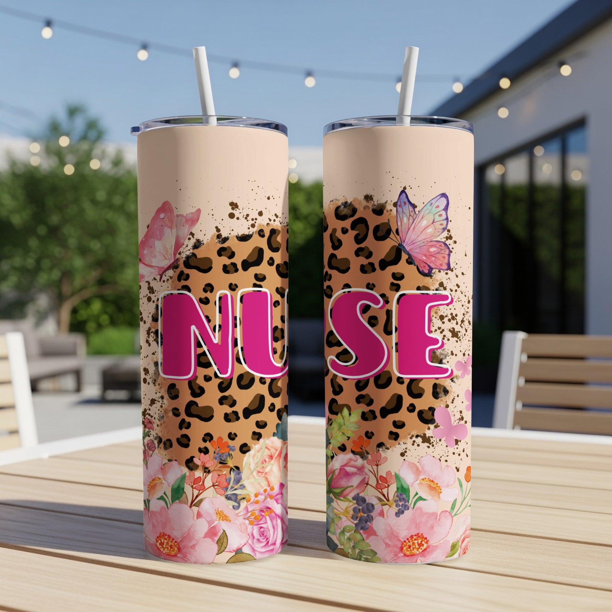 Pink "NUSE" tumbler with floral and leopard print, and butterflies.