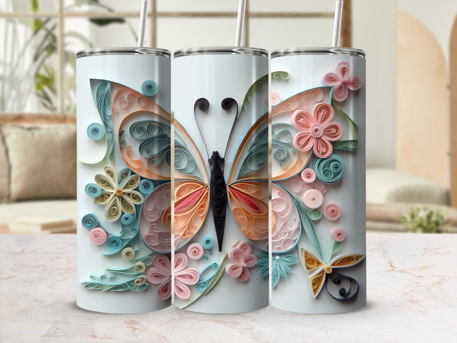 Three tumblers with a quilled butterfly and floral design.