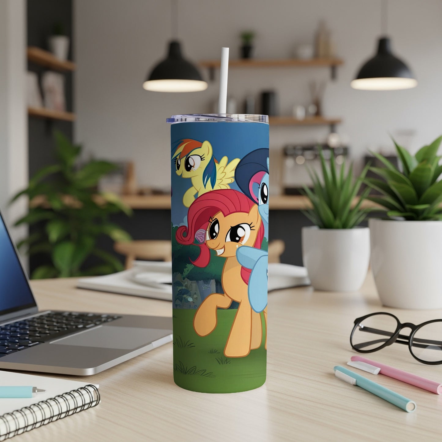 My Little Pony characters on a blue tumbler with a straw.