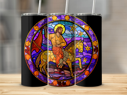 Stained glass tumbler with Jesus on a horse under a starry sky.