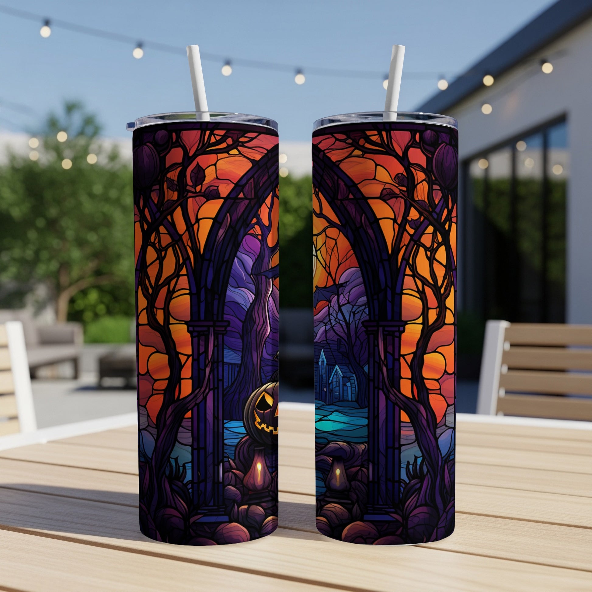 Two tumblers with a spooky Halloween scene featuring a pumpkin and arched gateway.