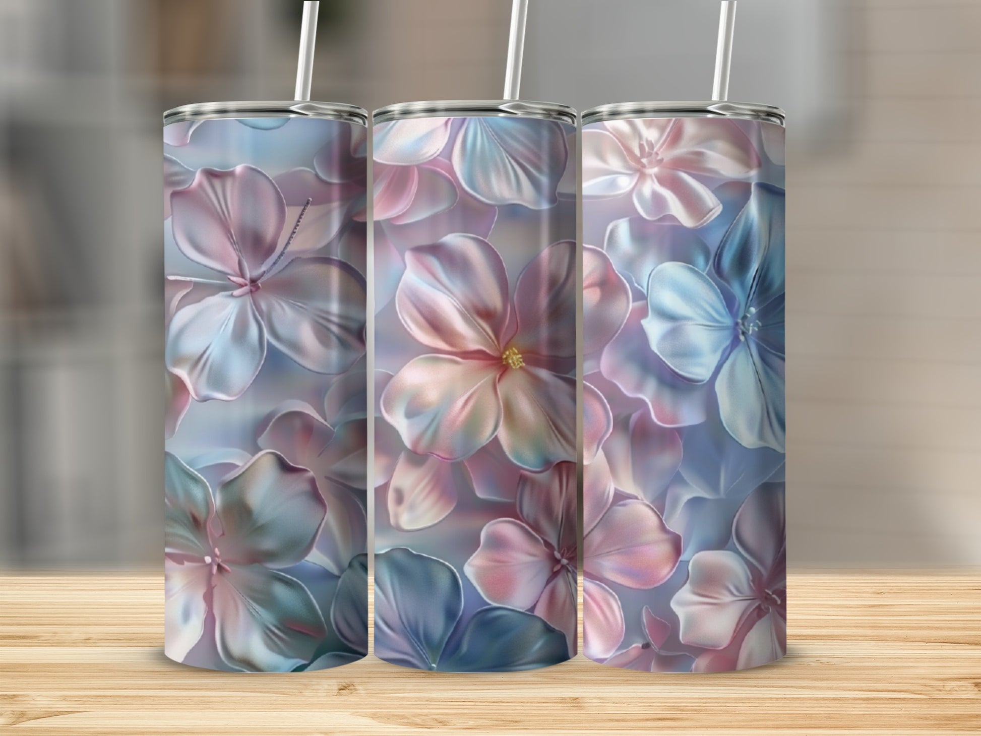 Three tumblers with pastel floral patterns and white straws.