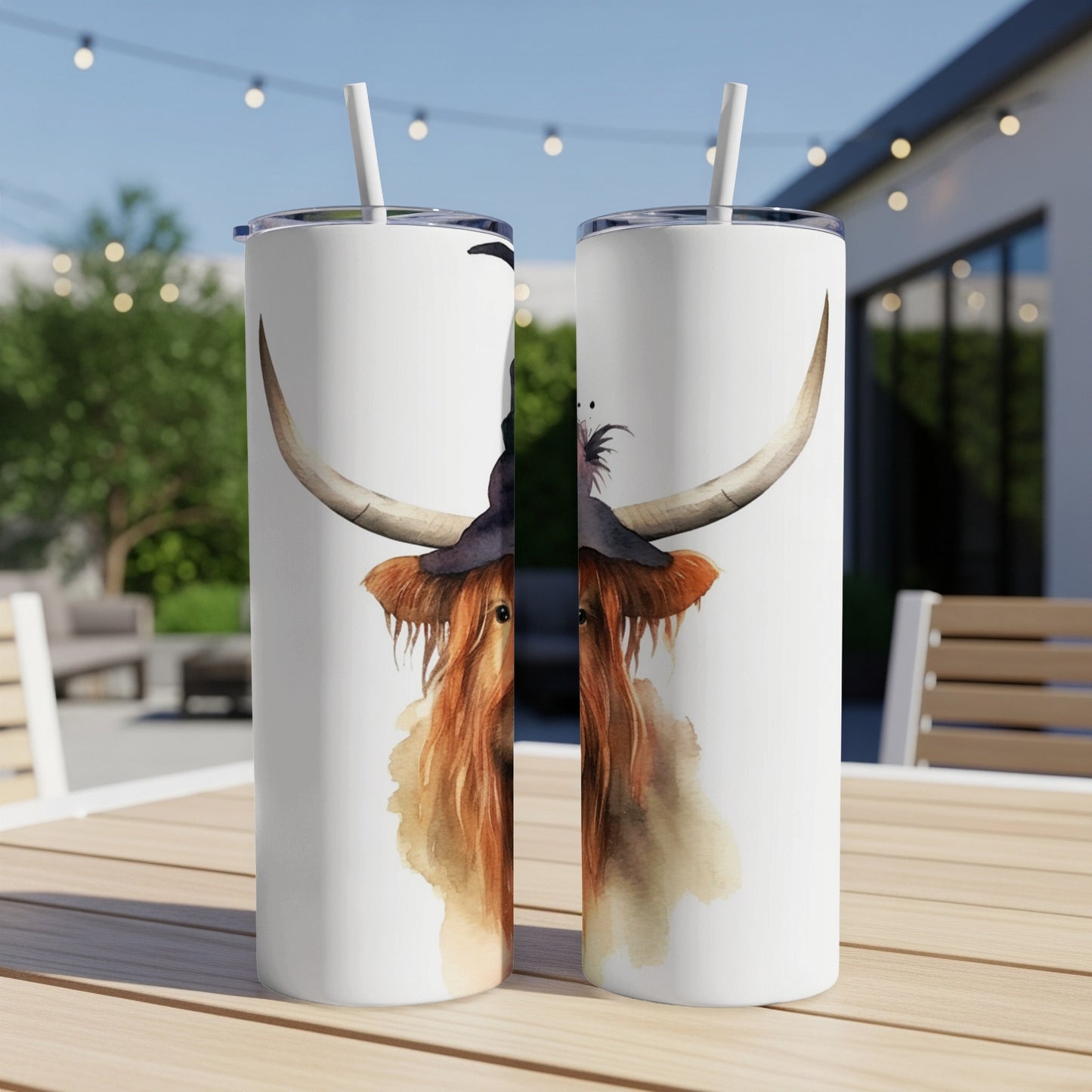 Two tumblers with watercolor highland cow wearing a witch hat.