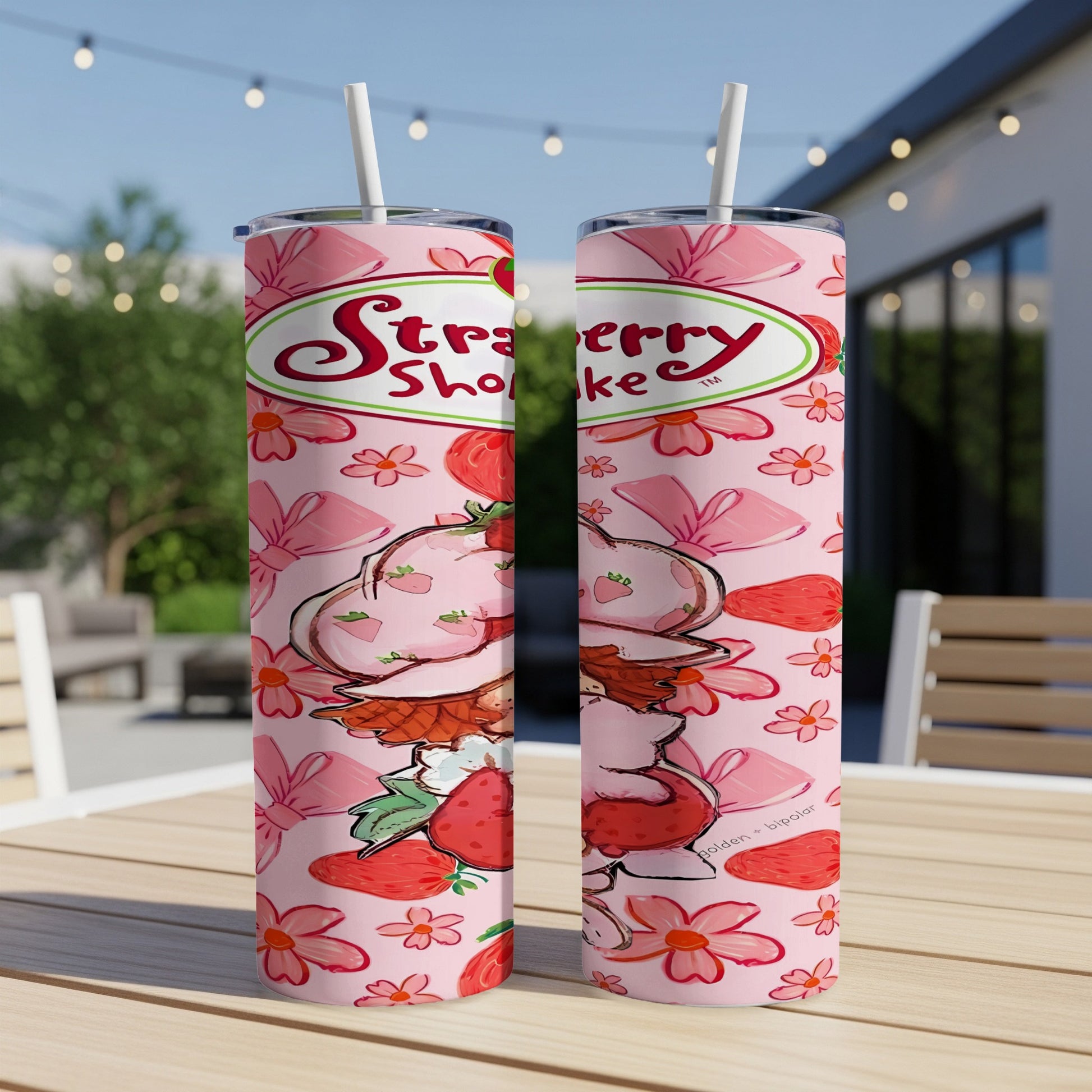 Strawberry Shortcake tumbler with pink floral and bow pattern.