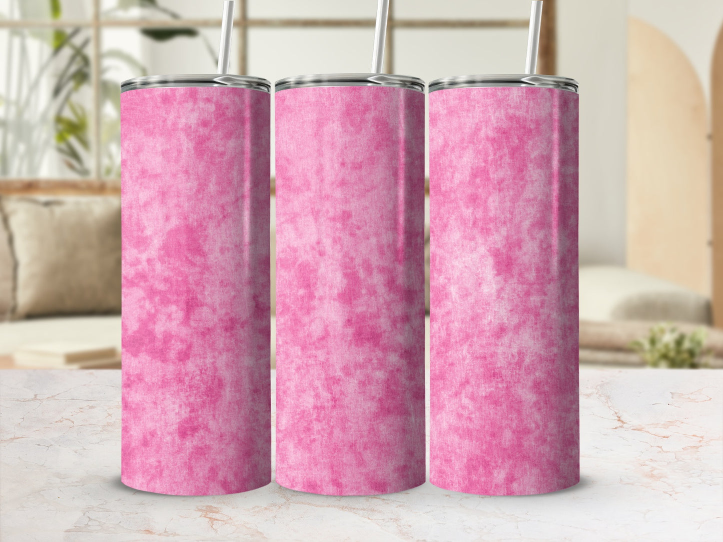 Three tall pink tumblers with marble texture and metal lids with straws.