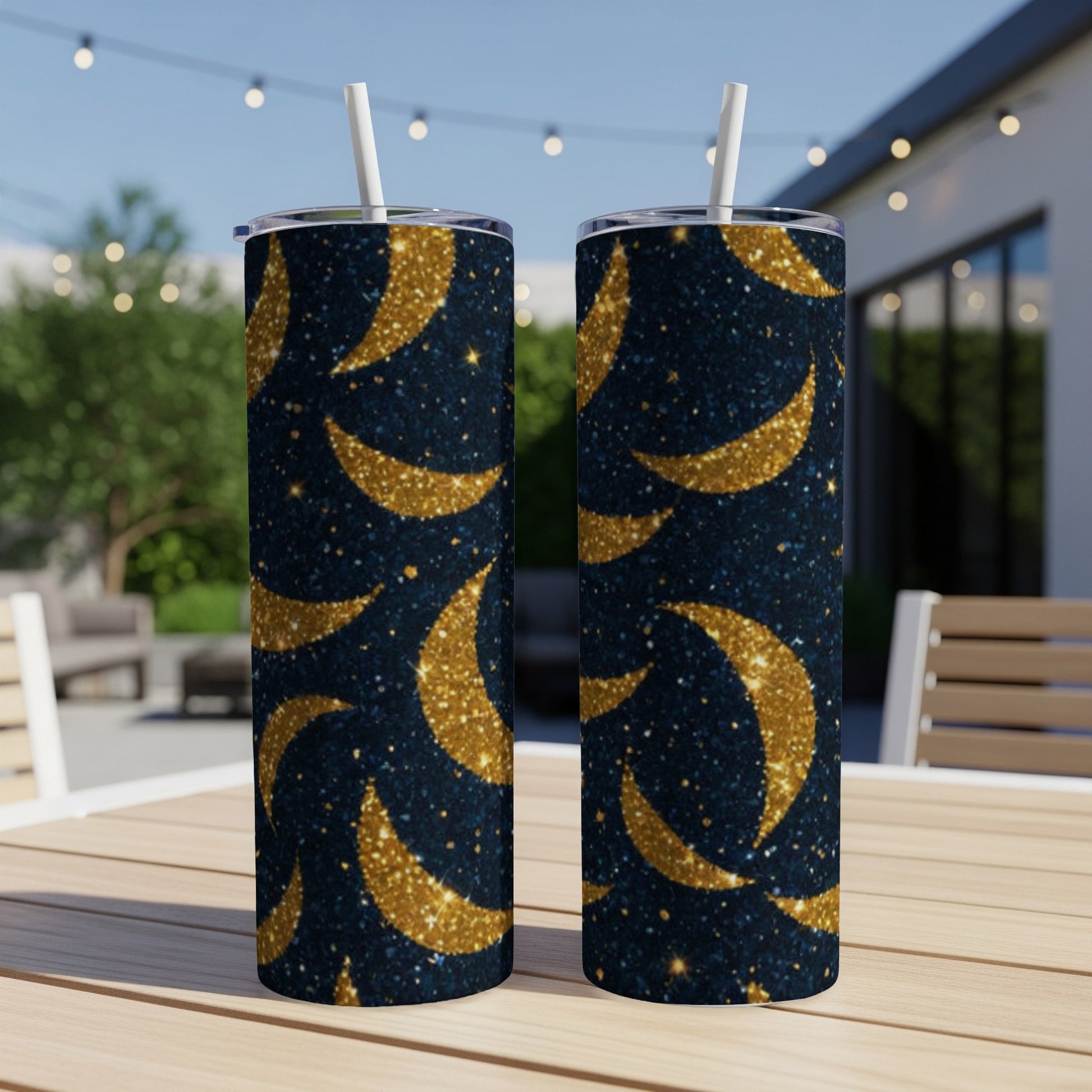 Two tall, glittery blue tumblers with golden crescent moon pattern.