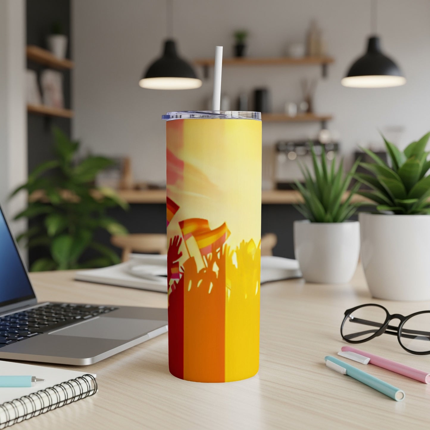 Rainbow-striped tumbler with a straw, set on a desk.