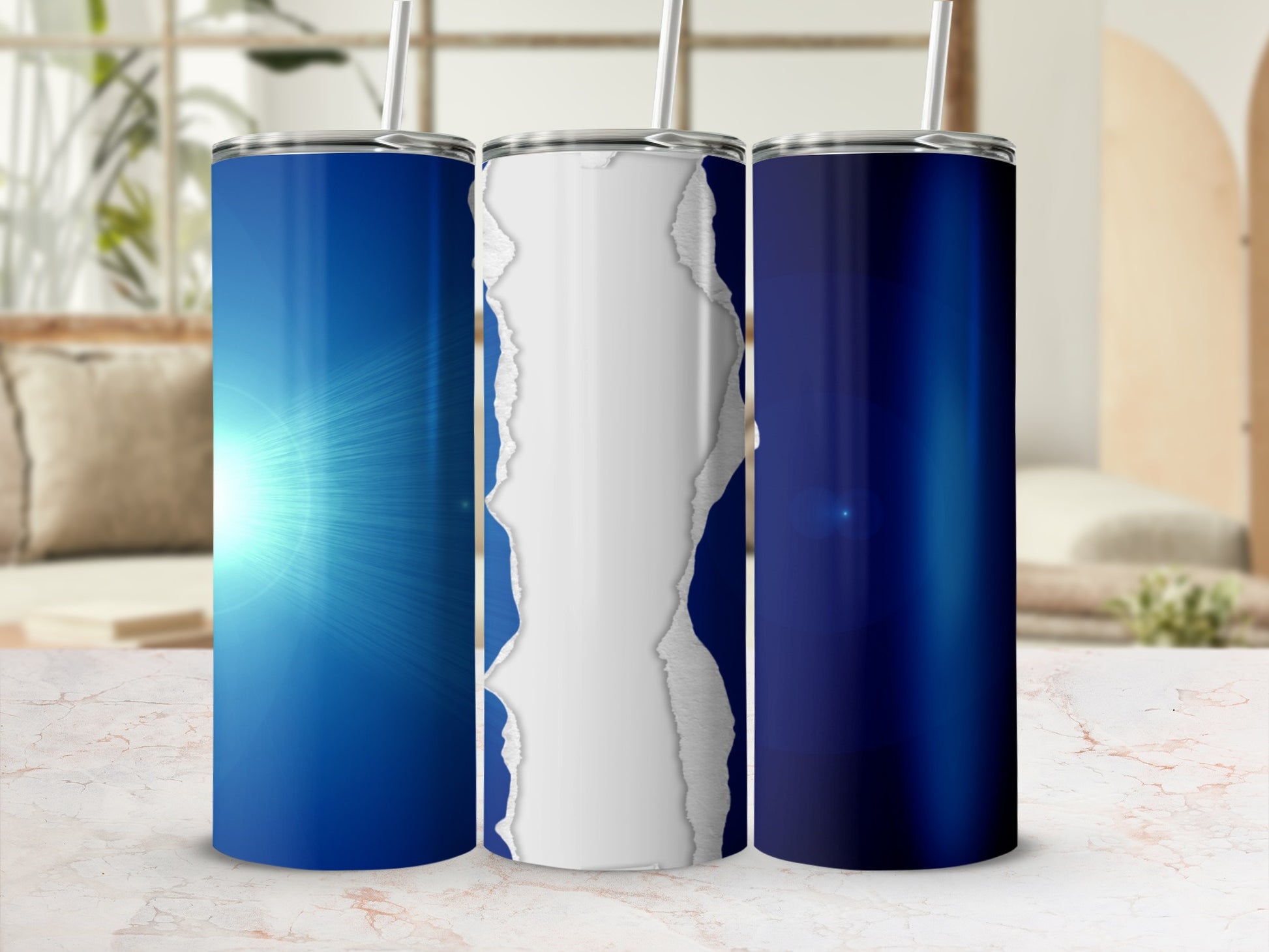 Three blue tumblers with ripped paper effect on a marble surface.