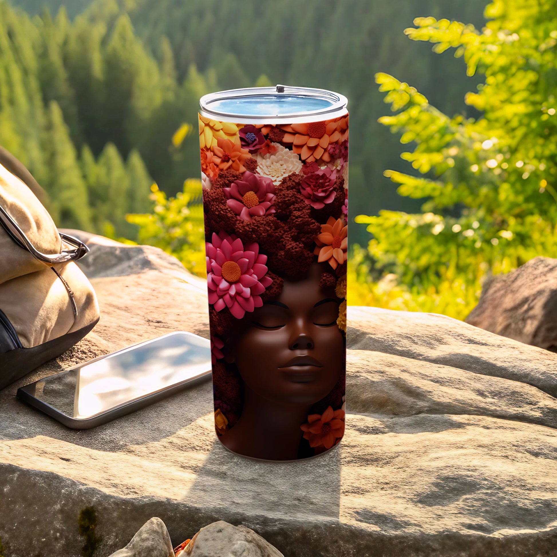 Tumbler with woman's face adorned with colorful flowers instead of hair.