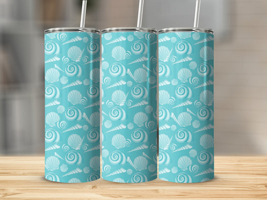 Blue tumbler with repeating seashell pattern and white straws.