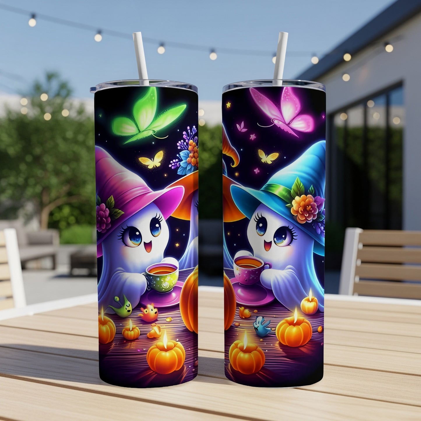 Two tumblers with cute ghosts, butterflies, pumpkins, and candles on a wooden table.
