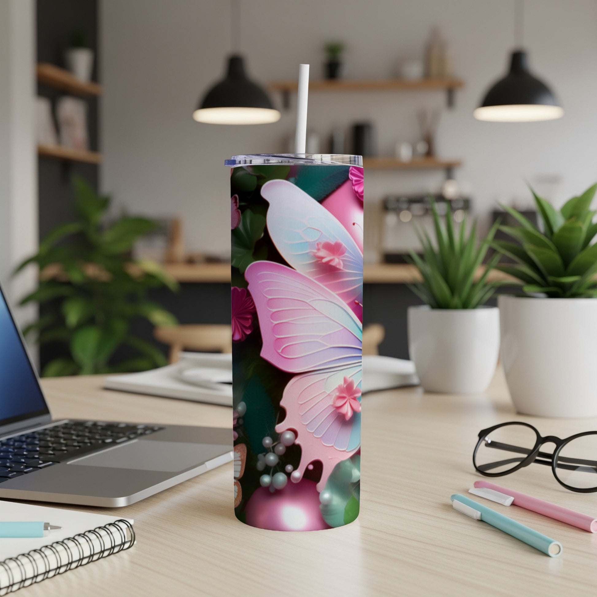 Pink and blue butterfly design on a white tumbler with a straw.