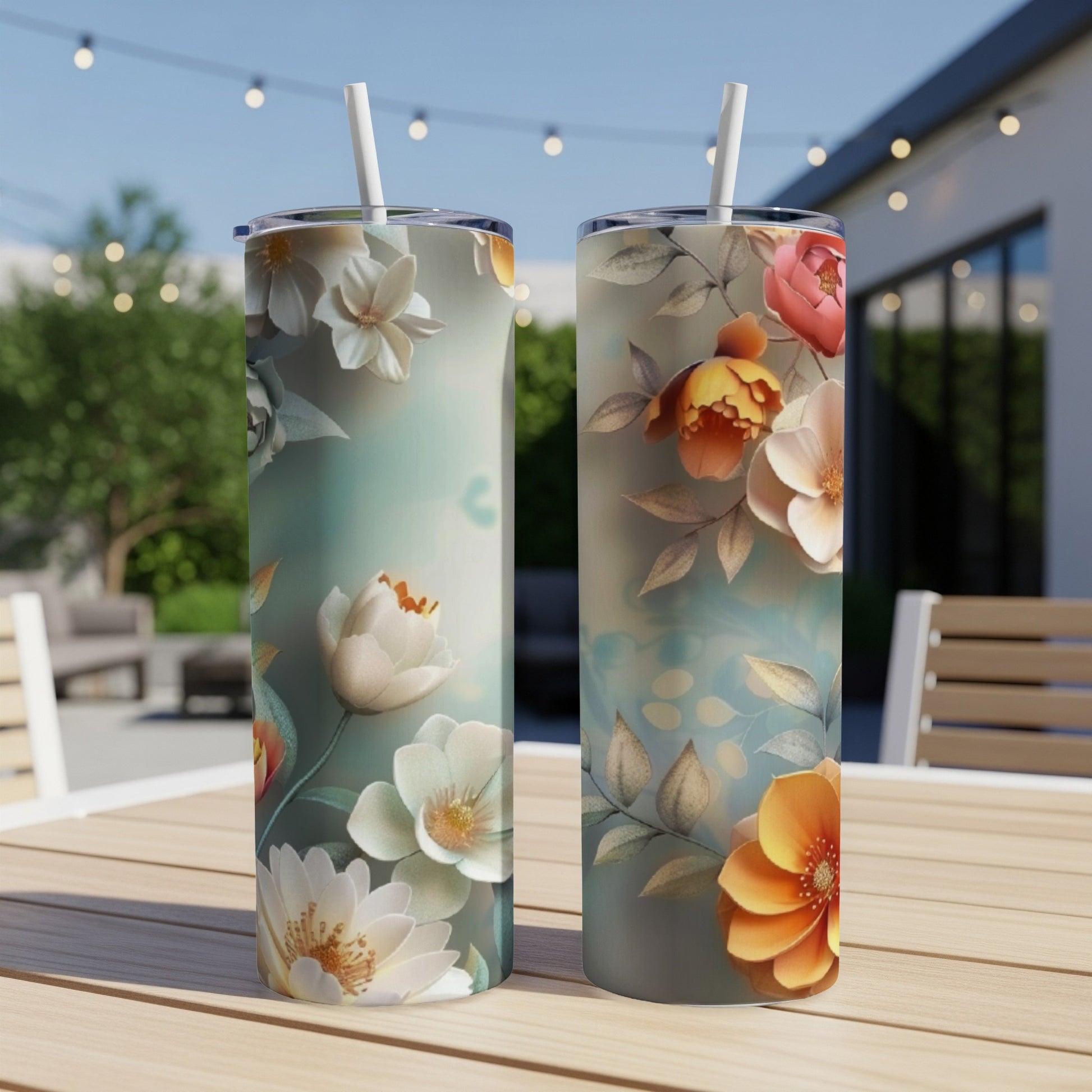 Two floral pattern tumblers on a wooden table with blurred outdoor background.