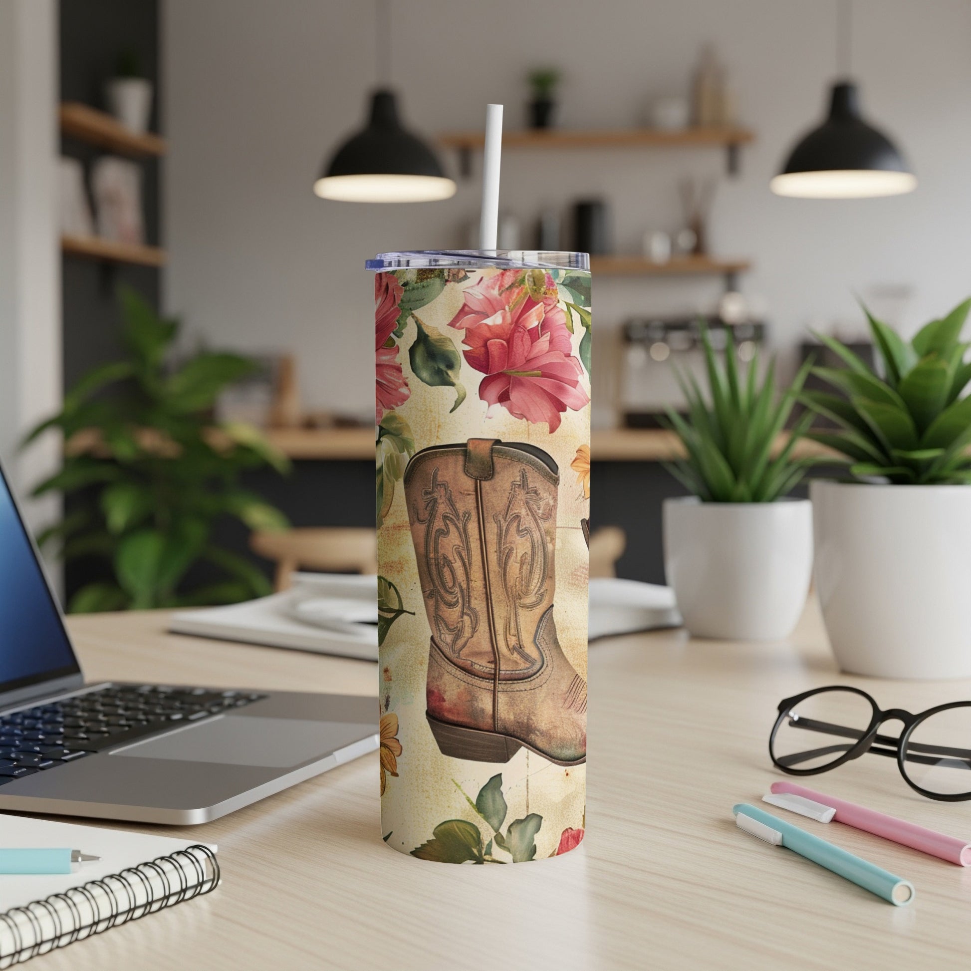 Cowboy boot with floral pattern on a tumbler with desk background.