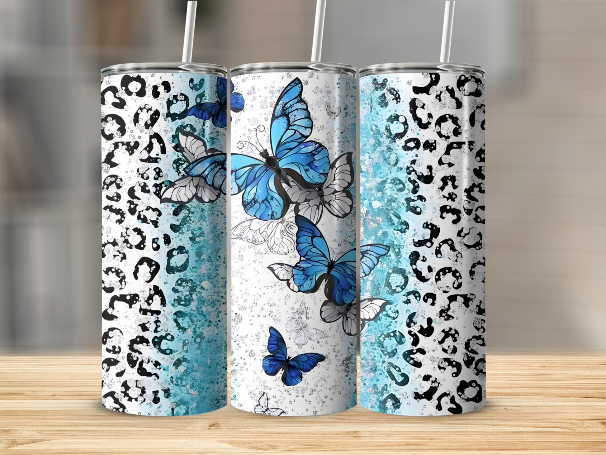 Three tumblers with leopard print and blue butterfly designs.