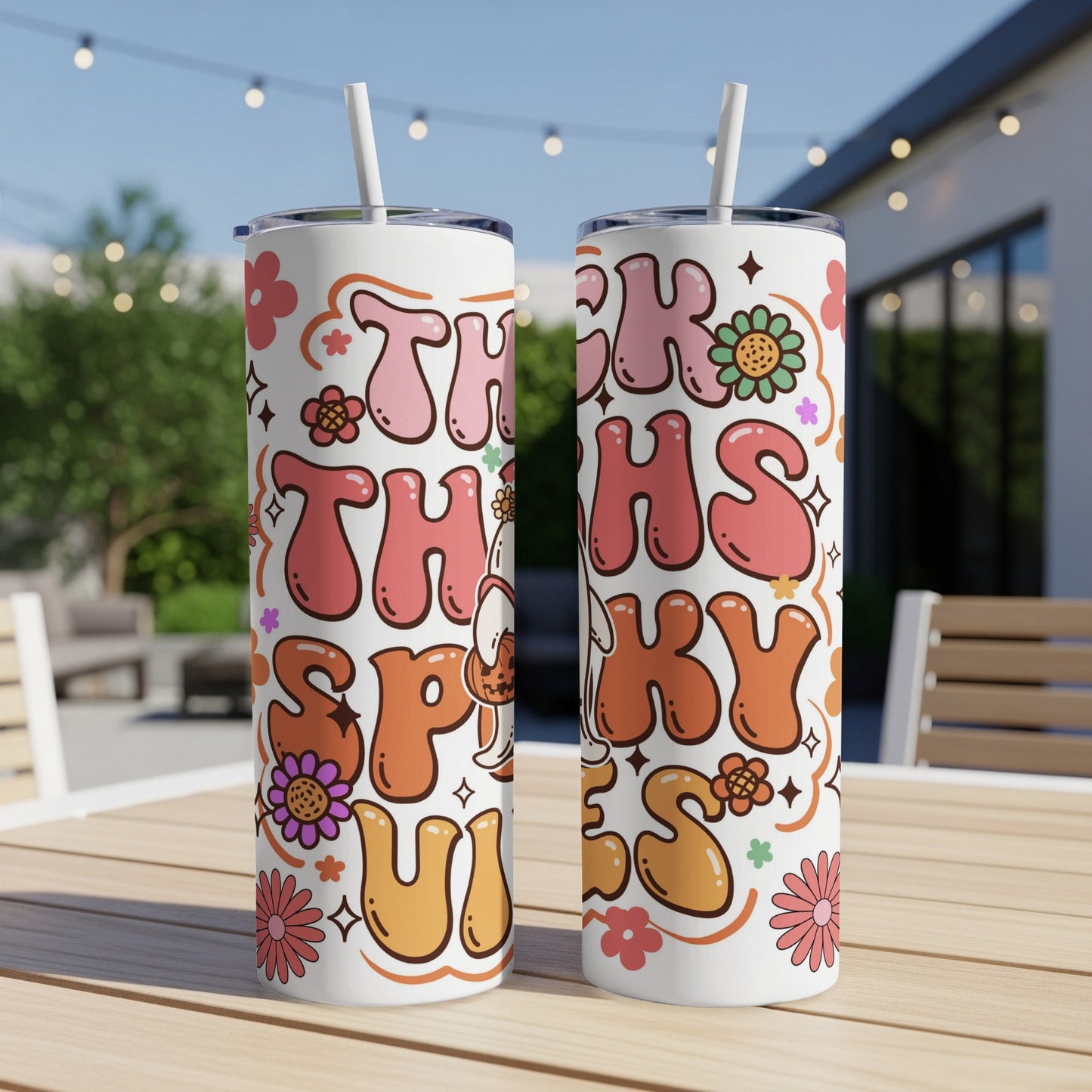 Two white tumblers with "This is Spooky" text and retro floral designs.
