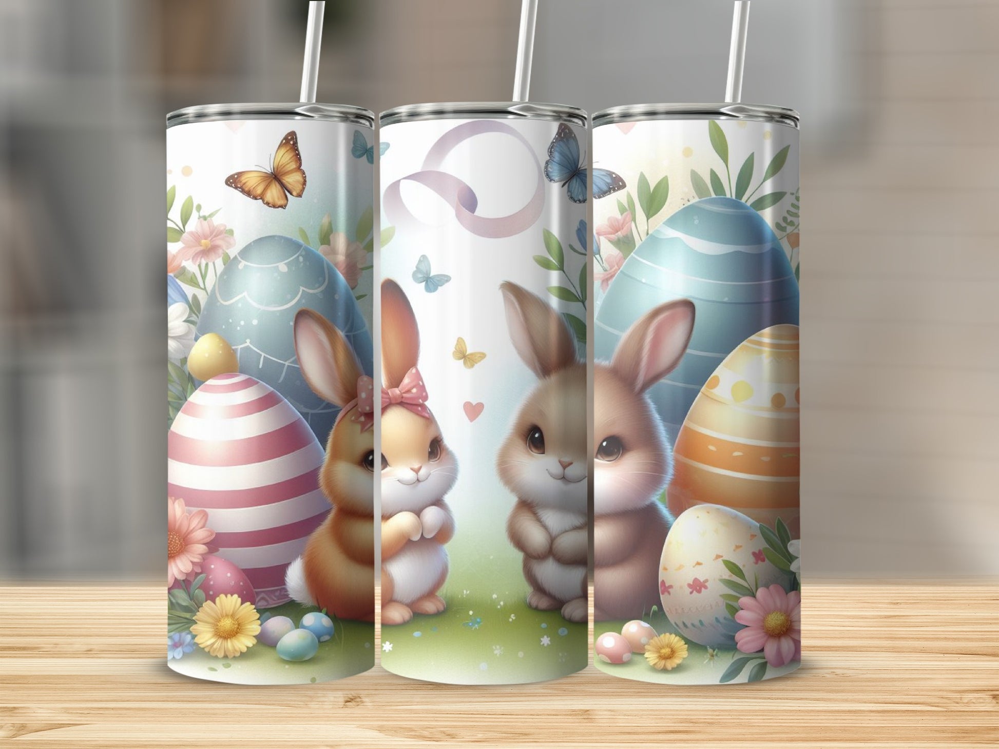 Three Easter-themed tumblers with bunnies, eggs, and butterflies.