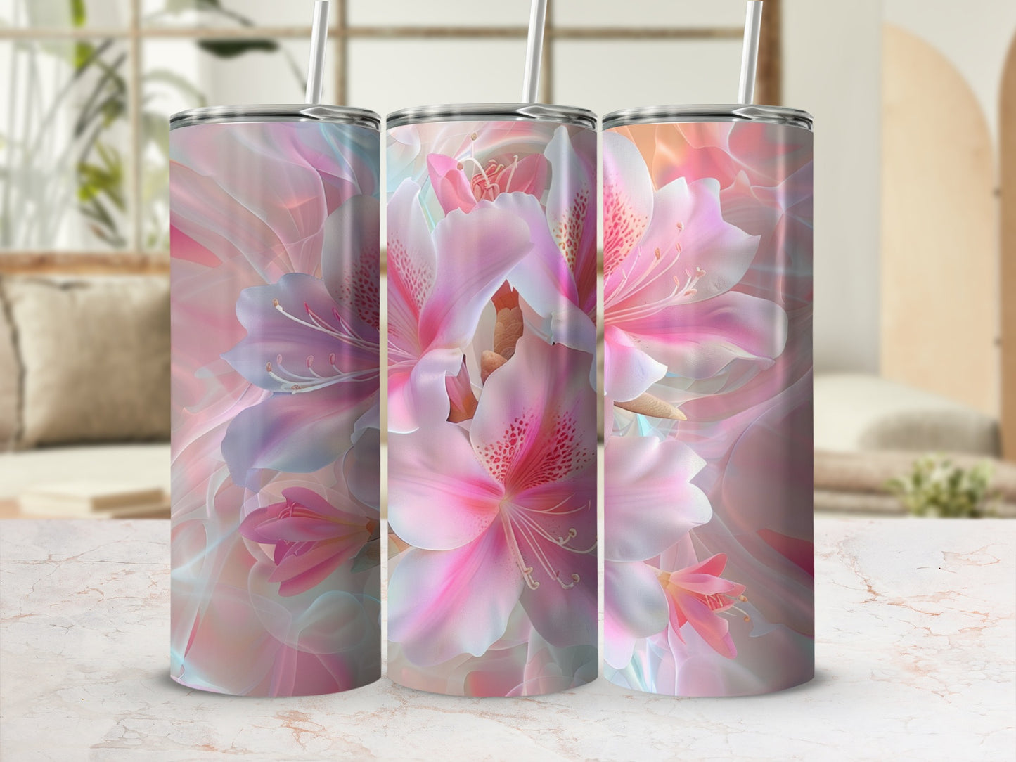 Three tumblers with abstract pink and blue floral designs and straws.