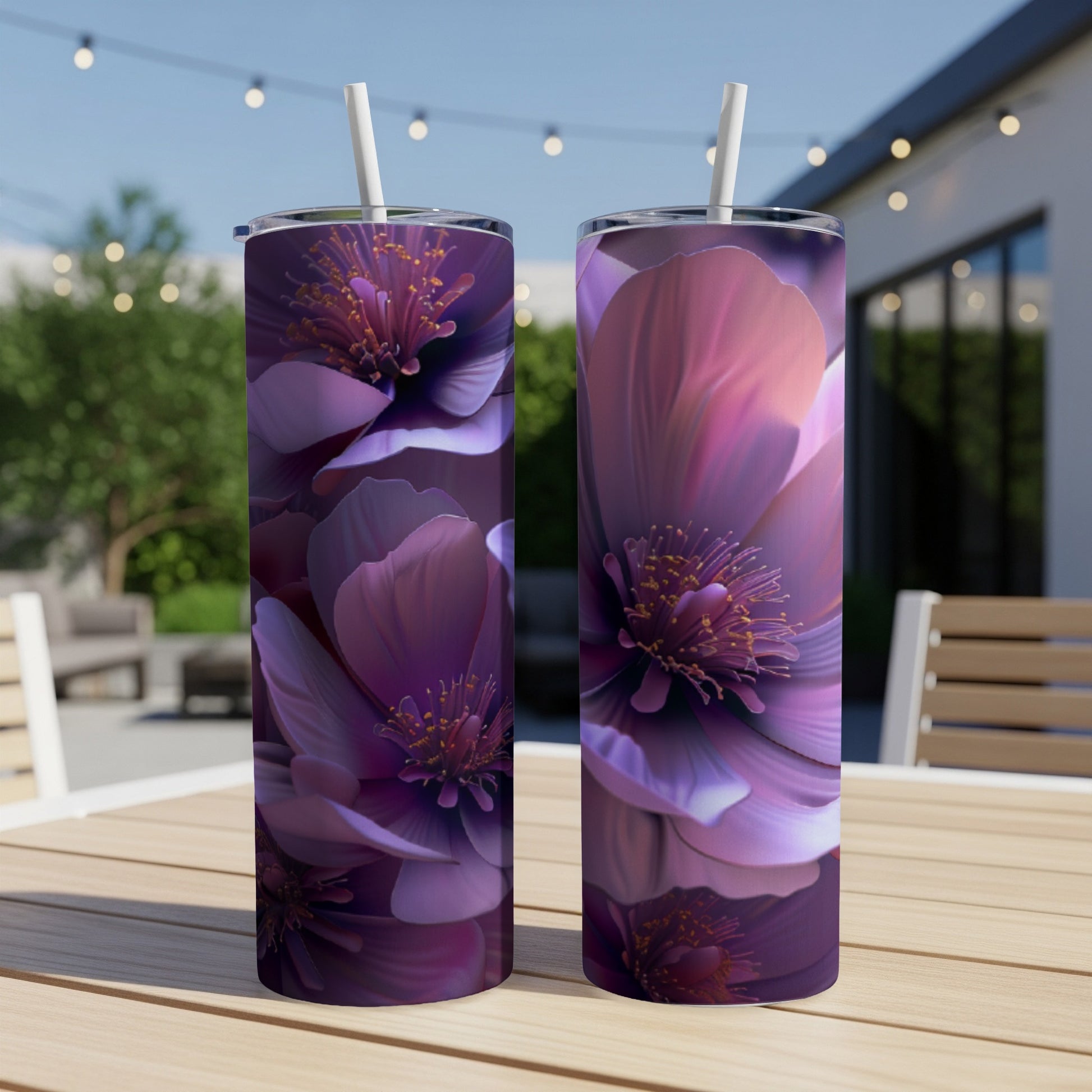 Two tall tumblers with vibrant purple floral print on a wooden table.