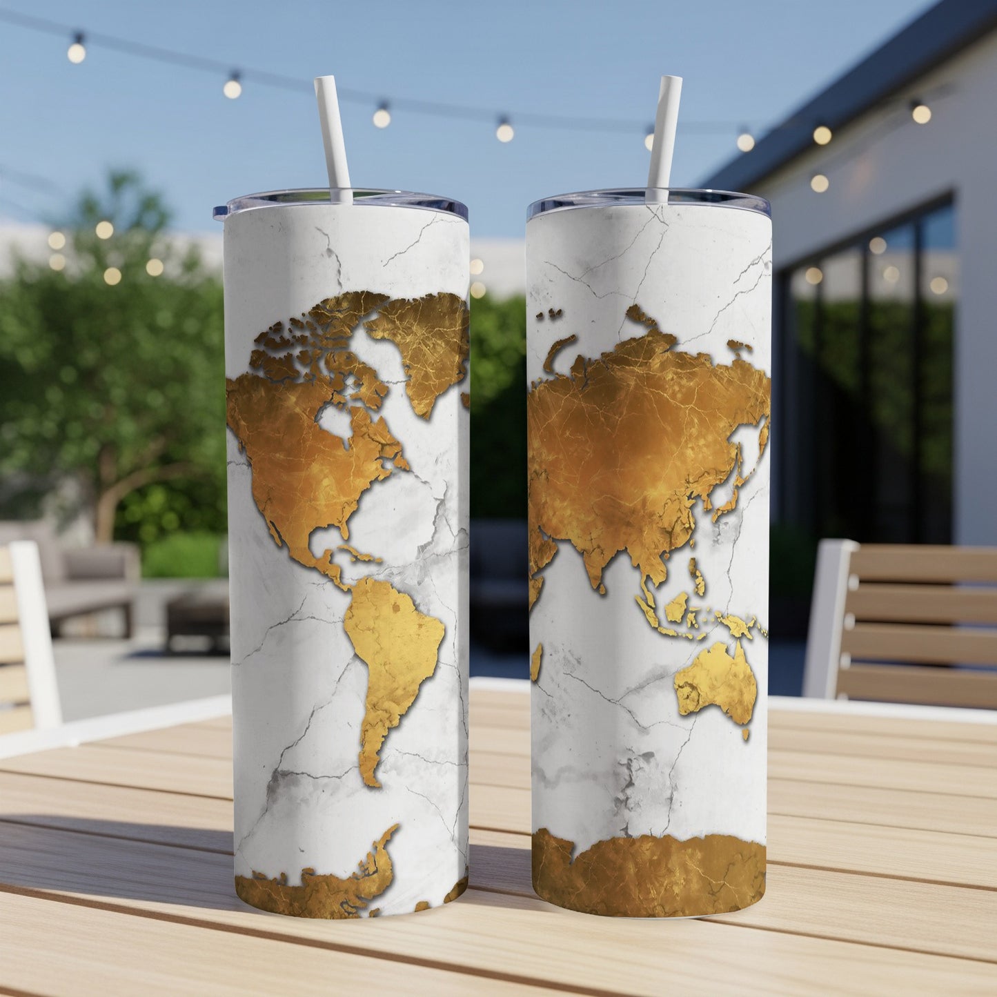 Two white tumblers with gold cracked map design, featuring straws.