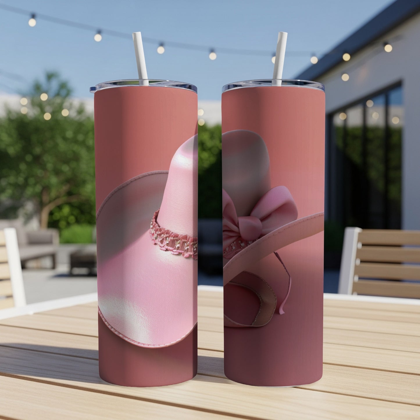 Two pink sun hats with bows and embellishments on a table.