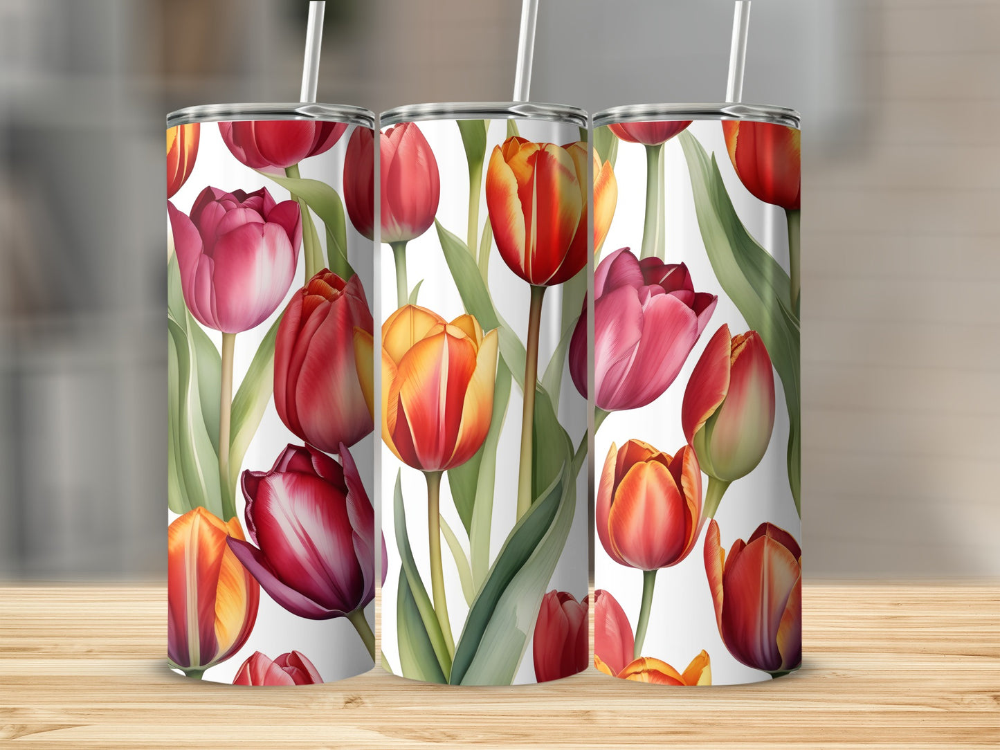 Three tumblers with a red and yellow tulip floral pattern on a wooden surface.