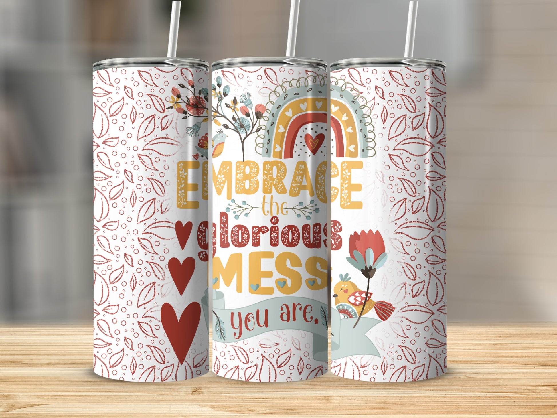 Tumbler with rainbow, birds, hearts, and text "Embrace the glorious MESS".