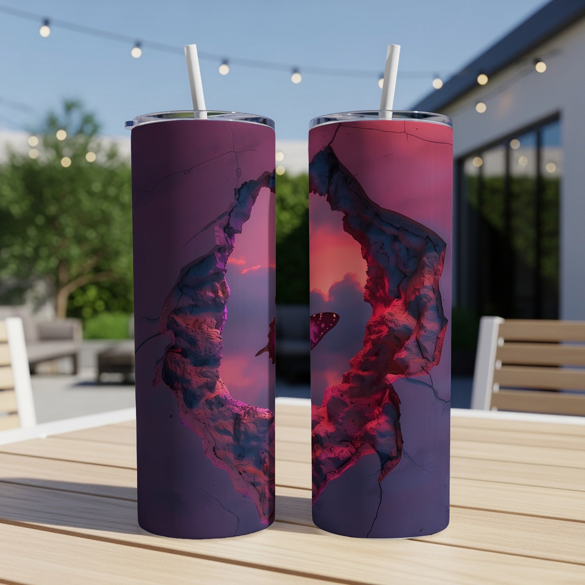 Two tumblers with a dark, cracked opening revealing a purple and pink sunset sky with a butterfly.