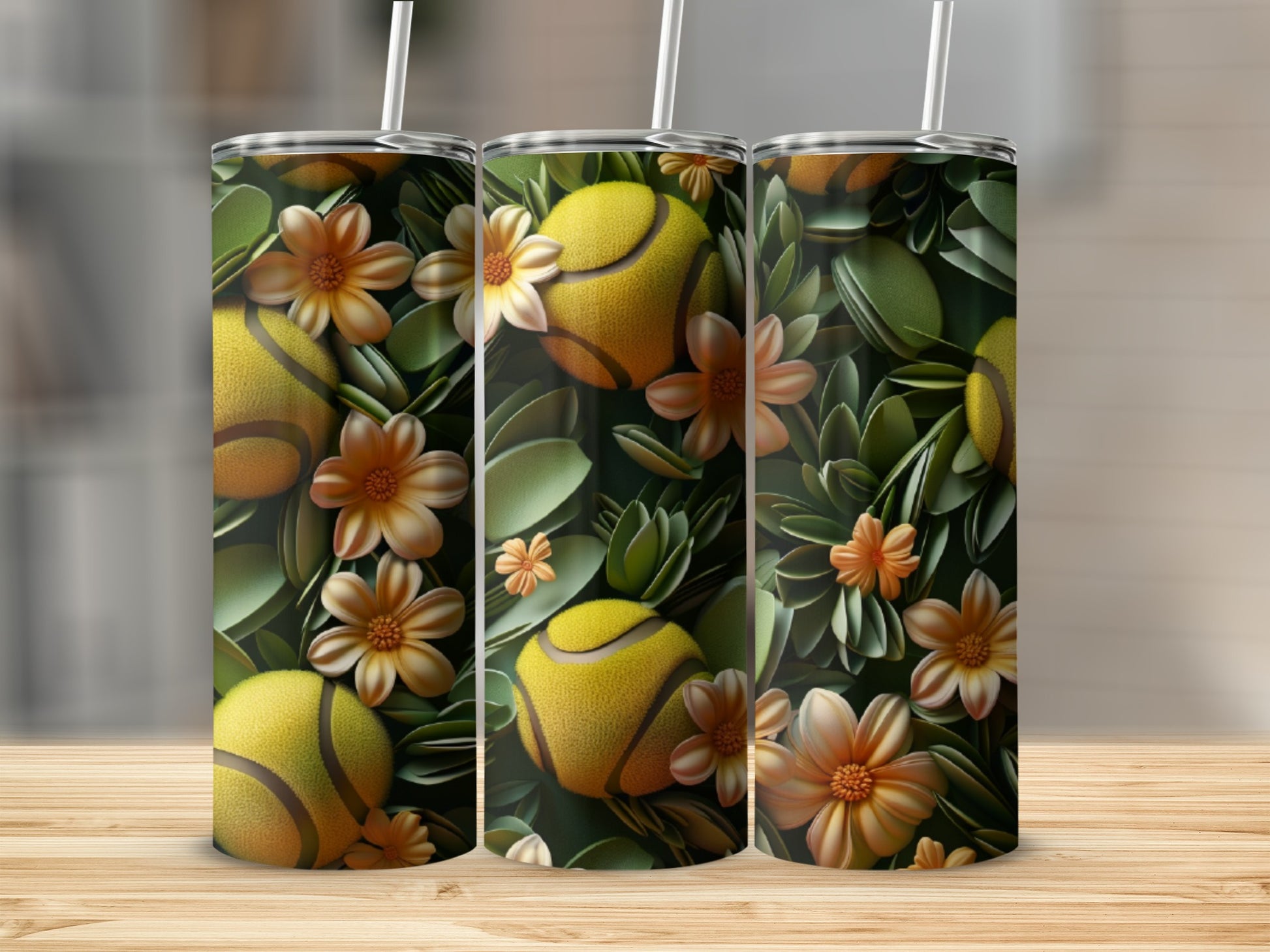 Tennis balls and orange flowers on a tumbler with a straw.