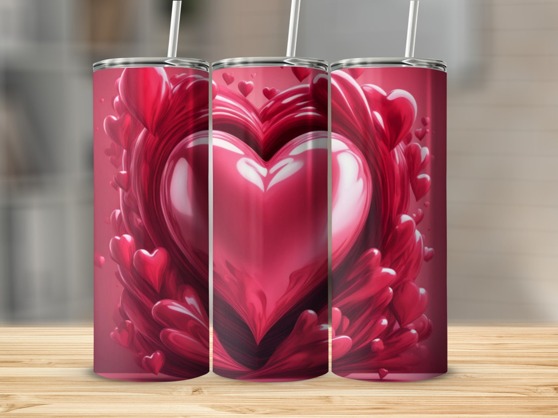 Three tumblers with a glossy red heart design and swirling red shapes.