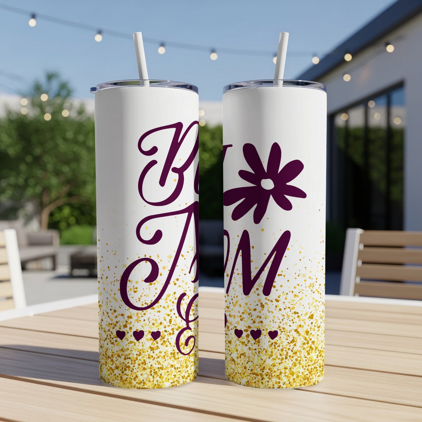 Two tumblers with "Best Mom" text and gold glitter accent on a patio table.