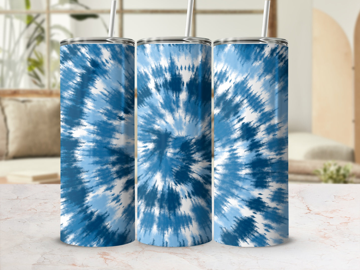 Three tumblers with blue and white tie-dye pattern and straws.