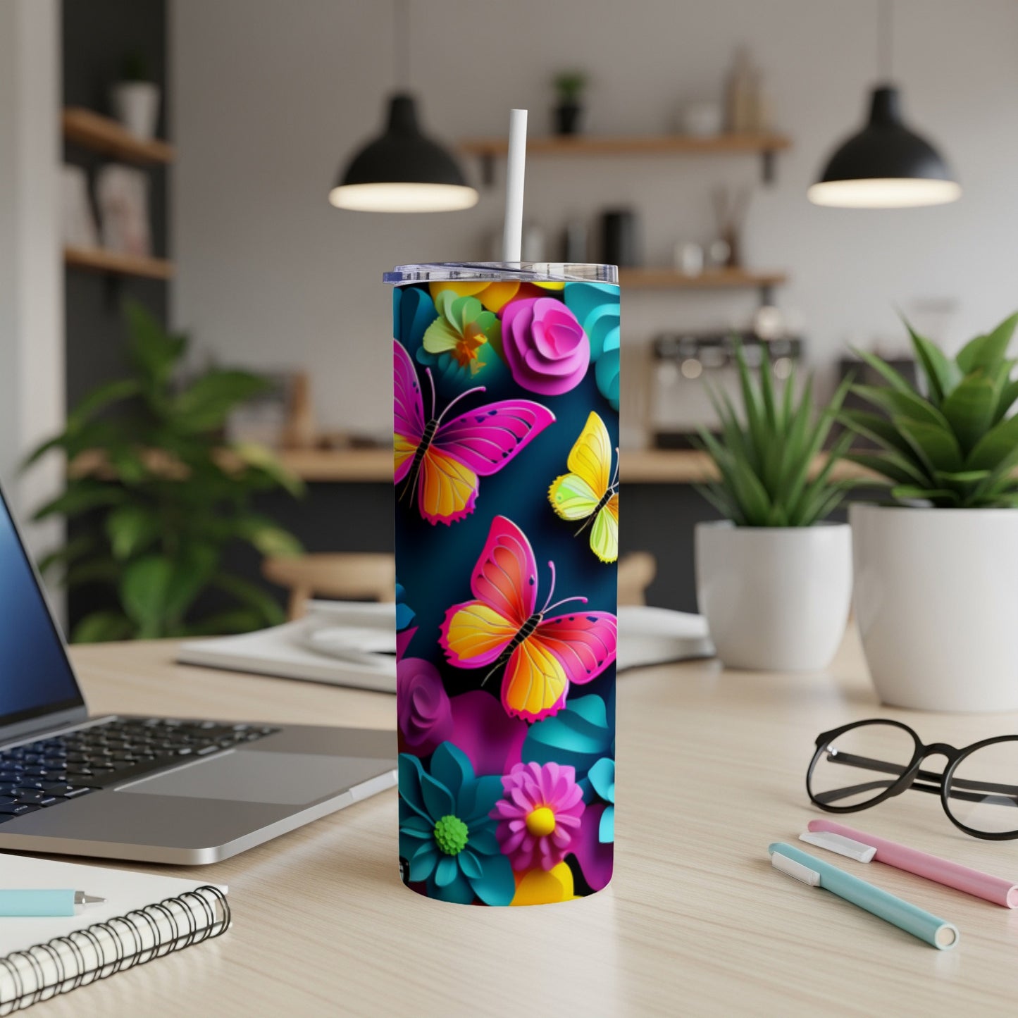 Tumbler with colorful butterflies and flowers against a dark background.