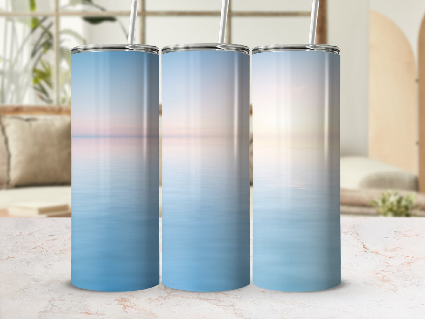 Three tumblers with serene ocean sunset design.