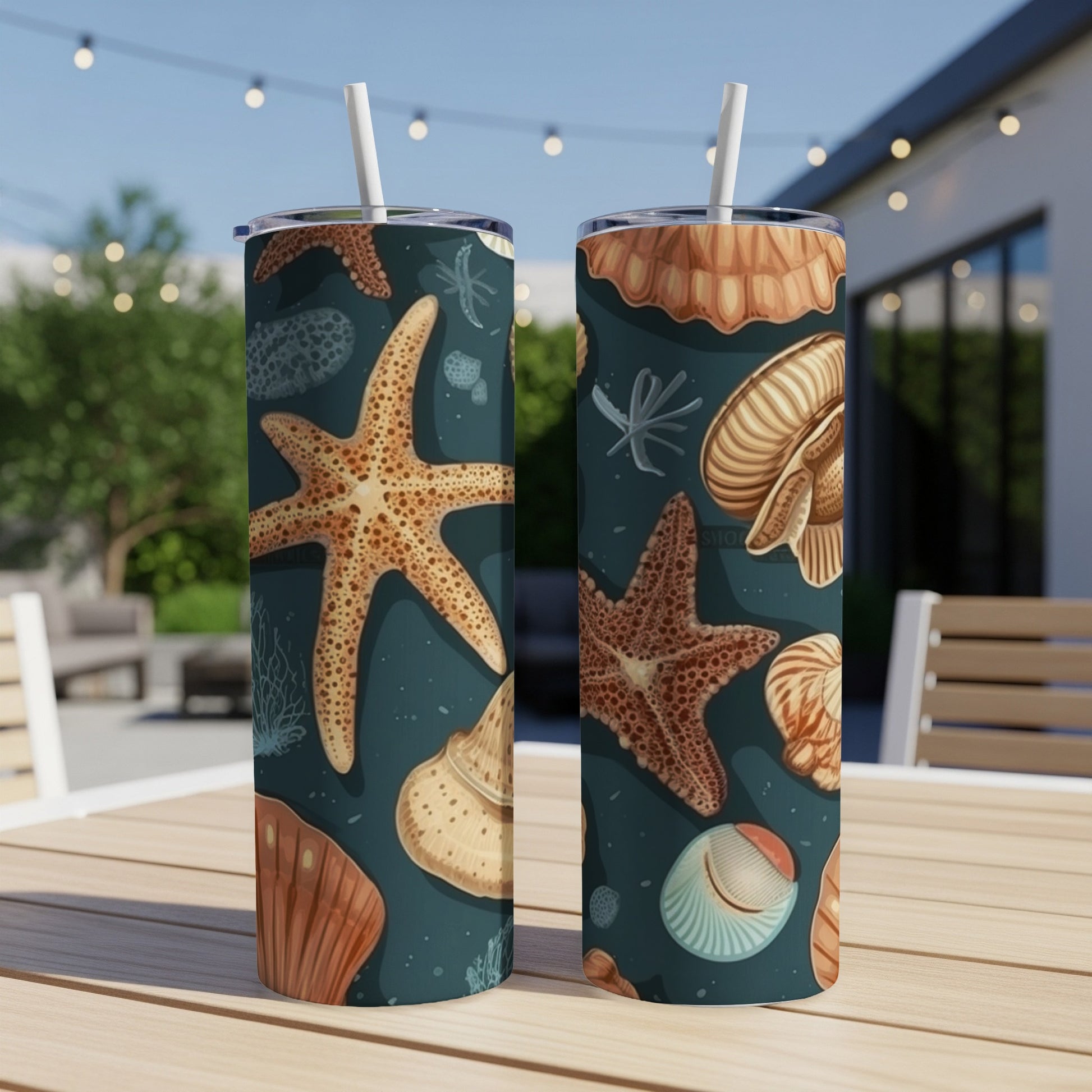 Two tumblers with a dark teal seashell and starfish pattern.