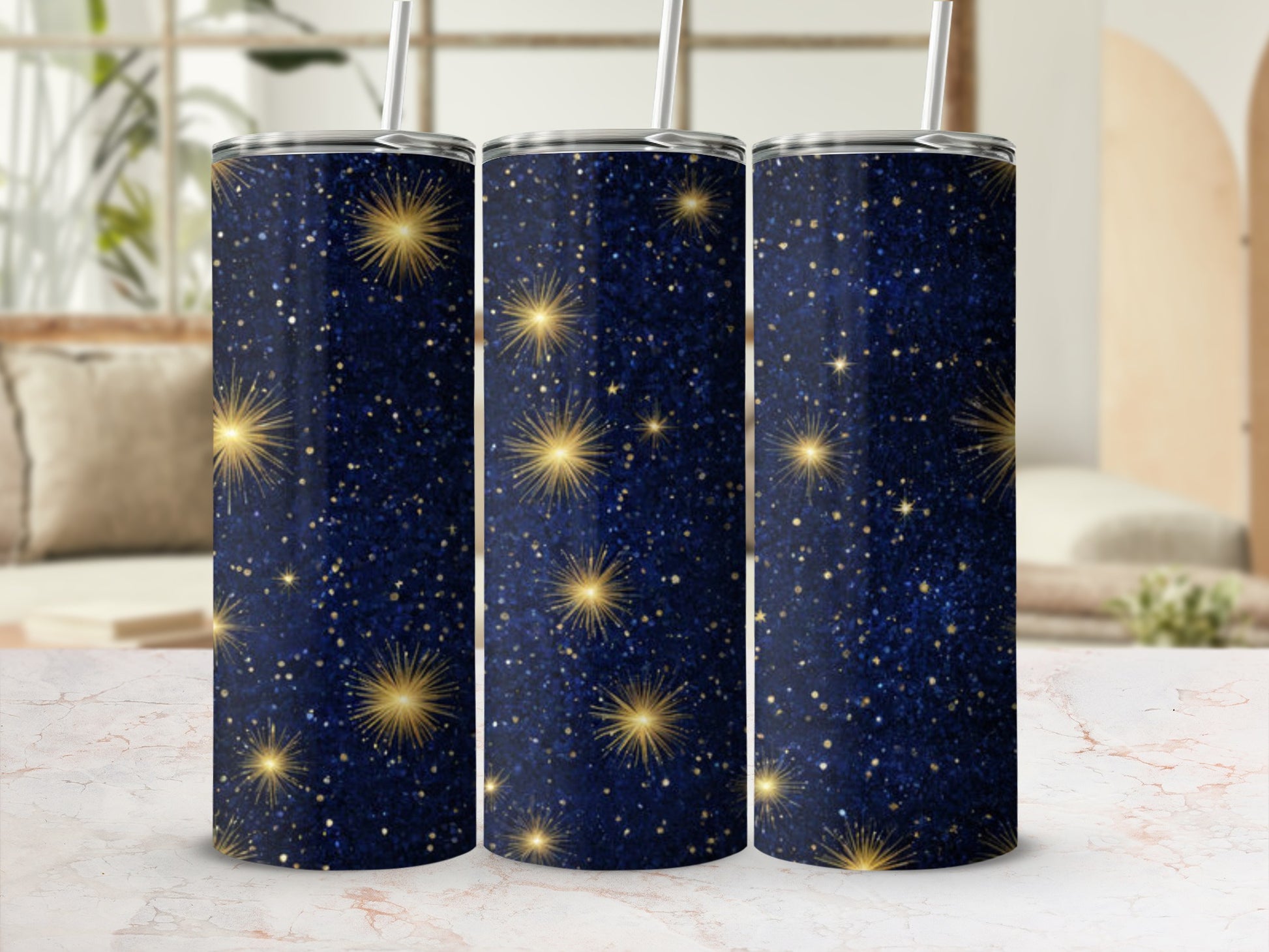 Three navy blue tumblers with scattered gold glitter stars and straws.