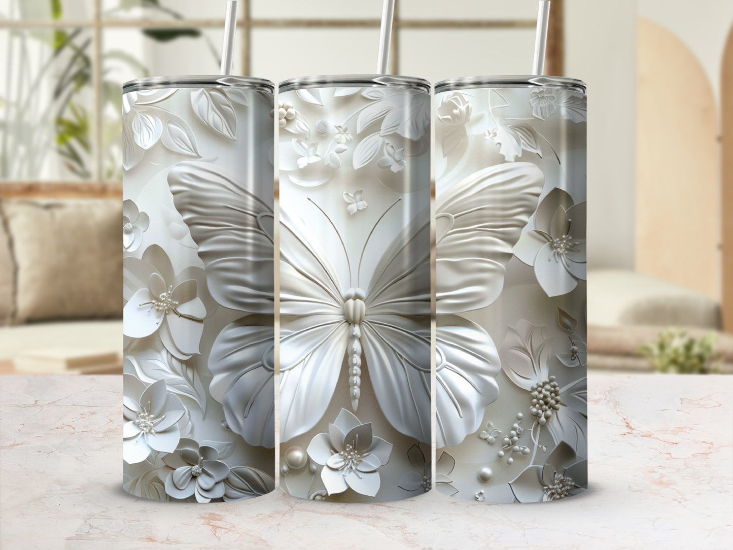 Three white tumblers with embossed butterfly and floral designs.