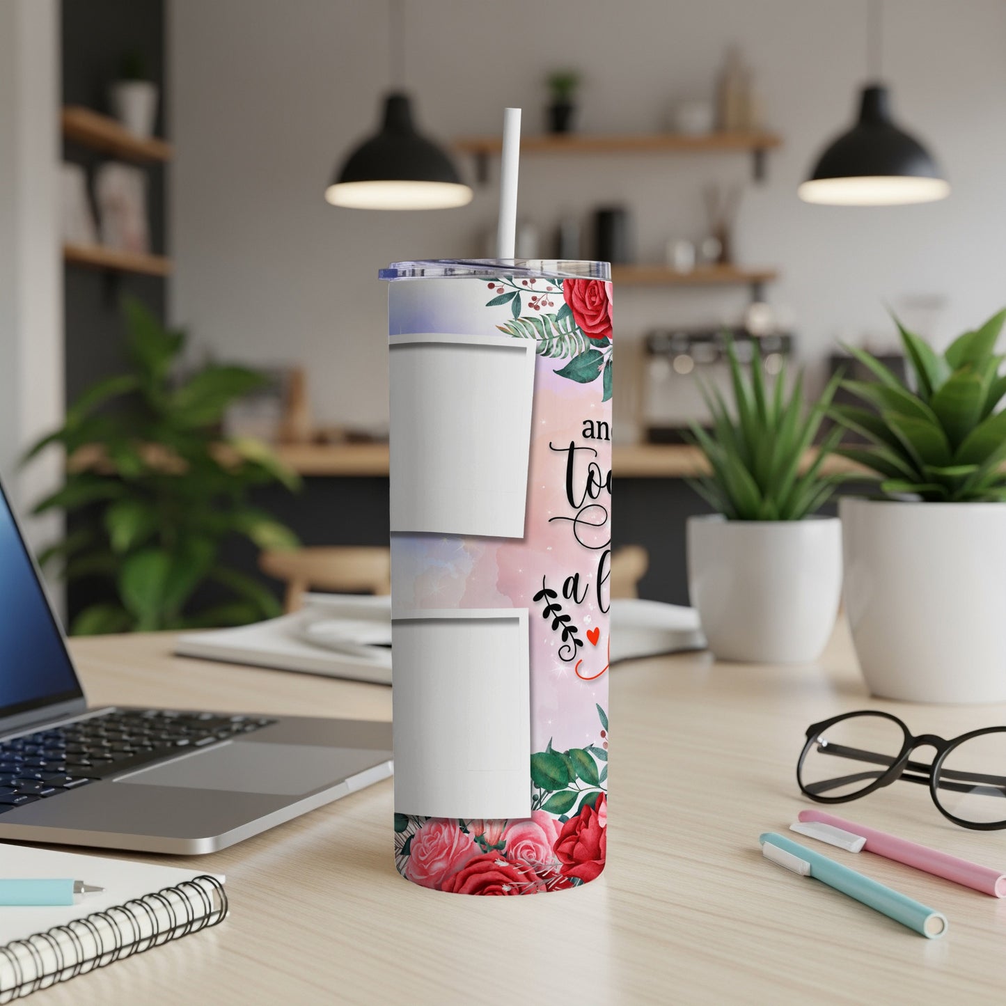 Floral tumbler with two photo placeholders and text "And to a" on a desk.