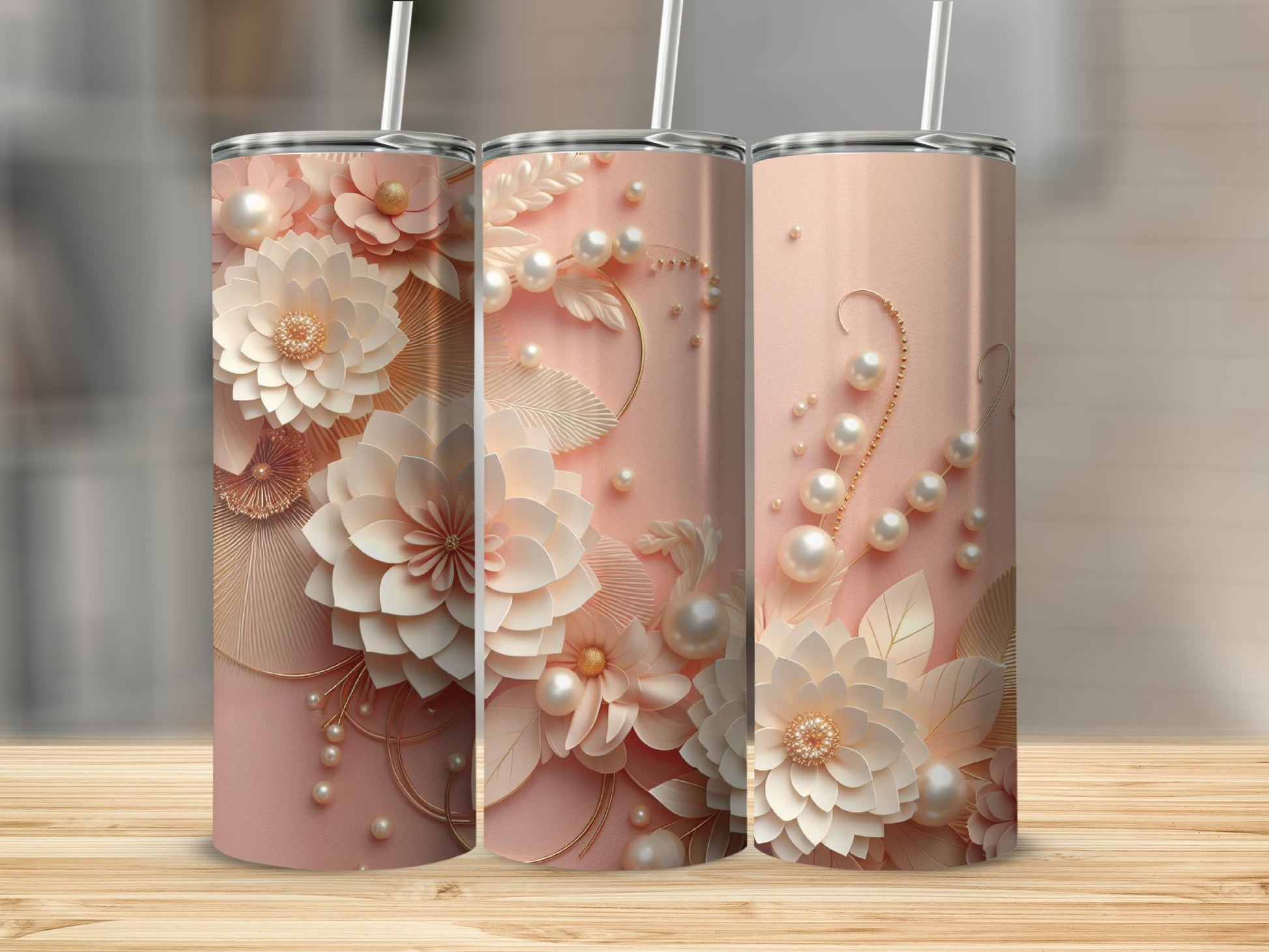 Three pastel pink tumblers with floral and pearl designs.