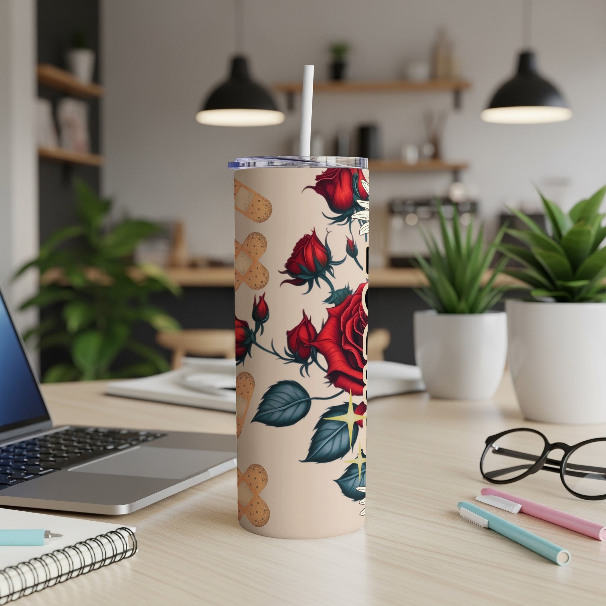 Red roses and medical cross pattern on a beige tumbler with straw.