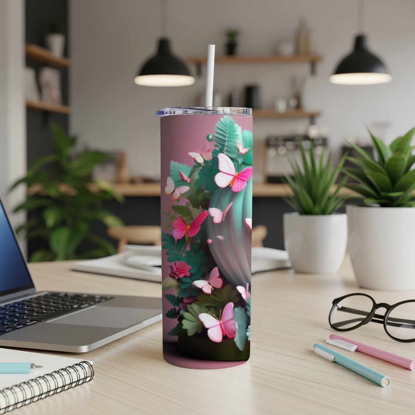 Pink tumbler with butterflies and floral accents.