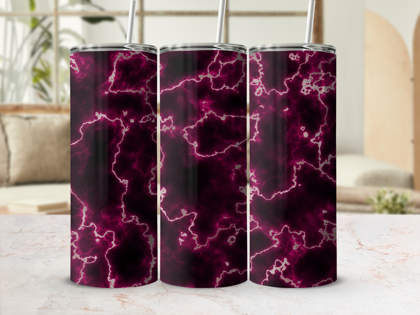 Three dark pink marble pattern tumblers with silver accents and straws.